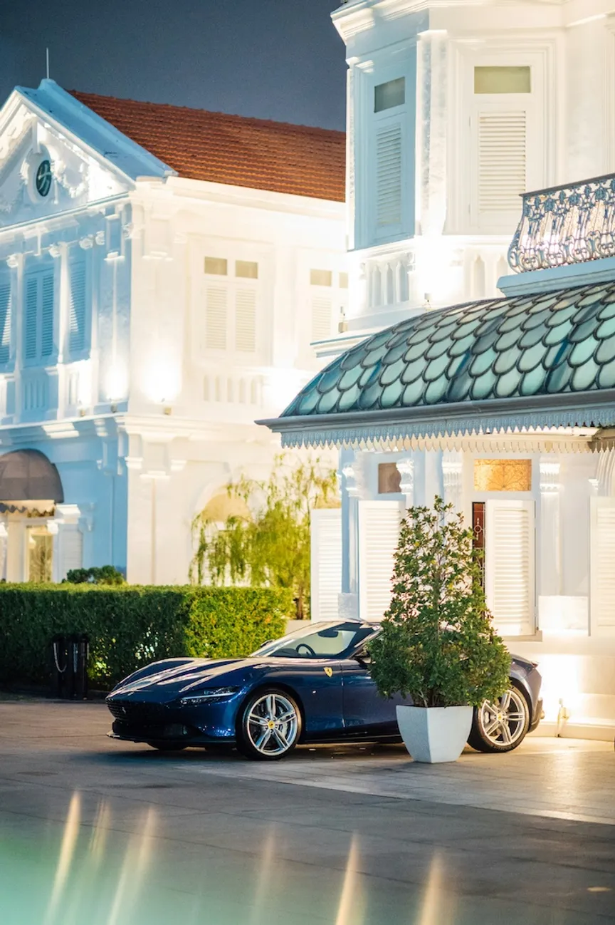 Luxury car parked in front of a fancy house